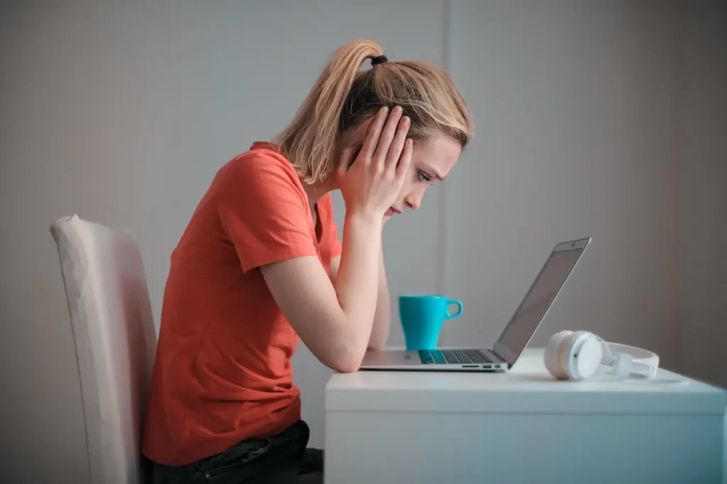 Women frustrating while looking at a laptop